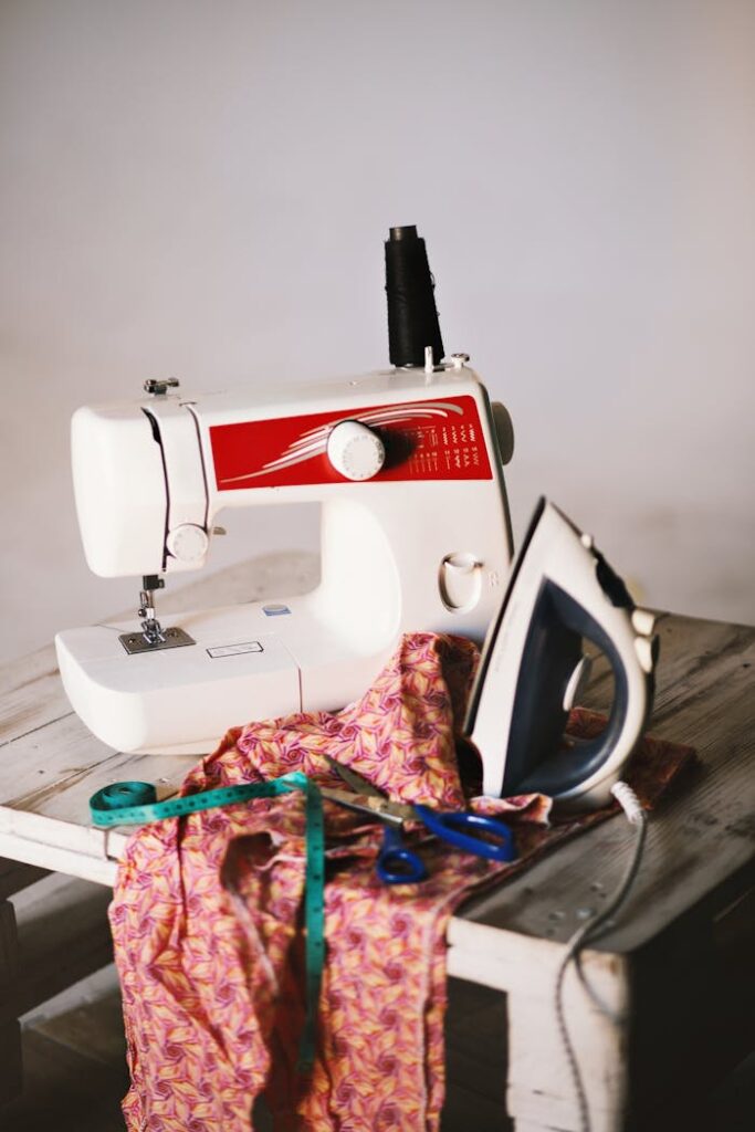 zipwp-image-1148963 White Sewing Machine, Clothes Iron, and Scissors